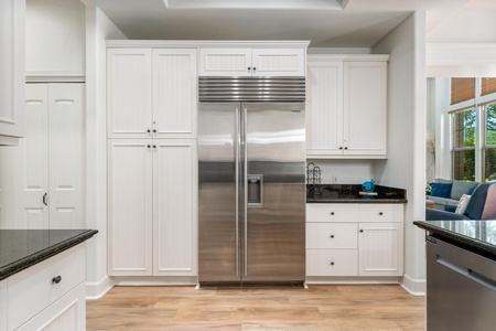 Your gourmet kitchen awaits with pristine white cabinetry, granite countertops, and professional-grade stainless steel appliances for memorable home-cooked meals.