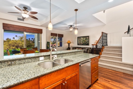 Full kitchen with breakfast bar, granite counters, and stainless steel appliances