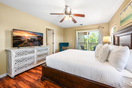 Sink into crisp white linens and let the gentle ceiling fan lull you to sleep. Your private balcony offers a peaceful spot to sip morning coffee while soaking in the natural light.