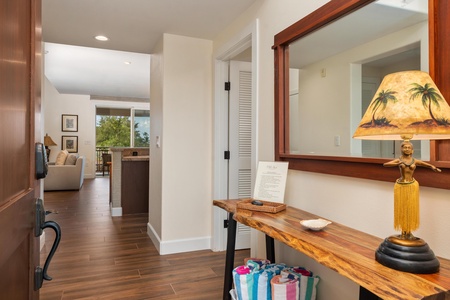 Step into your welcoming entryway, where tropical touches and rich wood flooring set the tone for relaxation.