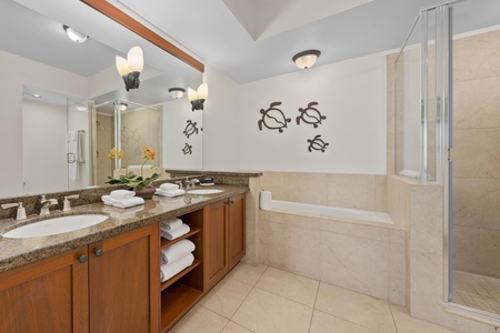 Unwind in your spa-like bathroom with a deep soaking tub, separate glass shower, and tropical turtle art that brings island charm to your daily routine.