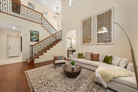 Unwind in your elegant living space with soaring ceilings, plush seating, and warm natural light streaming through.