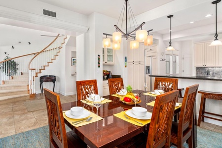 - Beautifully carved dining chairs and wood table anchor the room - Modern lighting and tropical accents make every meal memorable - Enjoy easy flow between dining, kitchen, and entryway spaces