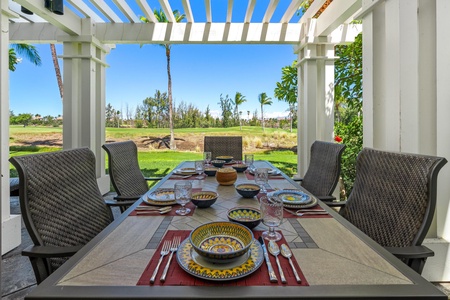 - Enjoy panoramic views of the golf course and palms from this outdoor dining retreat - Spacious table comfortably seats six with vibrant place settings - Covered pergola provides shade for relaxing afternoons together