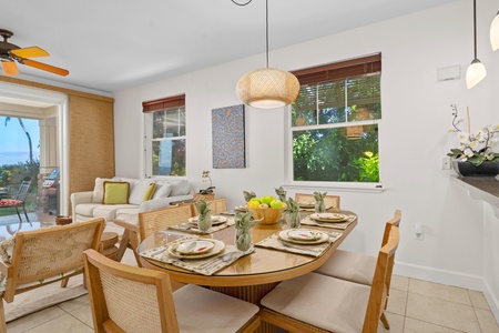 Your stylish dining space flows seamlessly into the living area, with warm wood accents and tropical views creating the perfect atmosphere for memorable meals together.