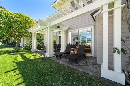 - Relax outdoors on cushioned lounge chairs beneath a shaded pergola overlooking beautiful lawns - Sliding doors connect the patio seamlessly to the living and dining space - Perfect spot for morning coffee, sunbathing, or unwinding in the breeze