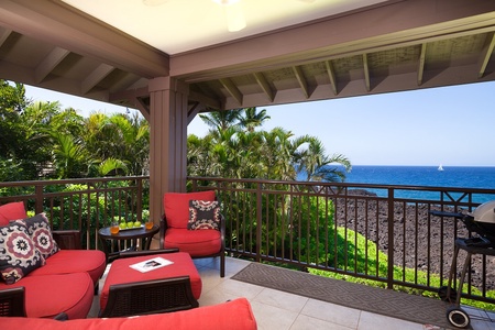 - Colorful lanai corner surrounded by tropical palms and unobstructed ocean views - Bright red cushions and wicker furniture offer a comfy place to relax outdoors - Sip coffee or cocktails while taking in the vibrant island greenery