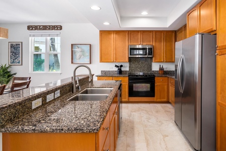 Well equipped kitchen with double sink and breakfast bar.