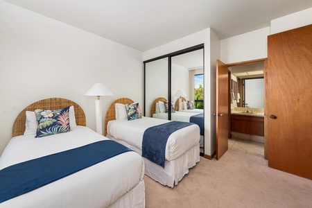 Drift off in your serene twin bedroom, where tropical-inspired linens and wicker headboards create a coastal retreat atmosphere.