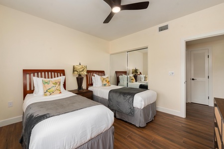 Drift off in your comfortable twin beds with crisp linens and tropical accents, while the ceiling fan keeps you cool.