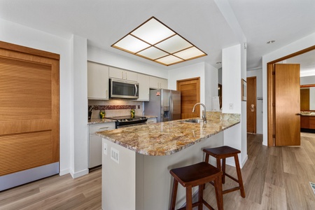 Your gourmet kitchen features sleek granite countertops, modern stainless appliances, and a sunny breakfast bar where you'll sip morning coffee and plan daily adventures.