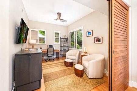- Bright home office with large windows wood desk & ergonomic chair for productive work - Cozy seating area with cream armchairs & small wood tables adds comfort & versatility - Neutral tones & natural light create a calm inspiring environment for daily t