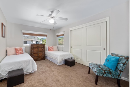 - Bright guest room with two twin beds, soft carpeting, and peaceful garden views - Sliding closet doors and wood chest offer plenty of storage for your stay - Cozy setup ideal for kids, friends, or extra family members