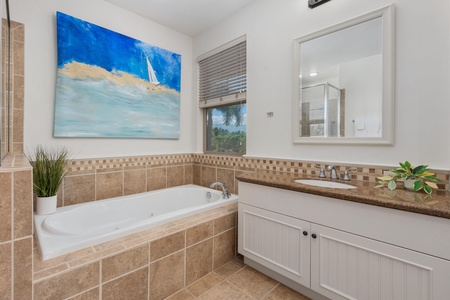 Soak away your stress in this elegant soaking tub surrounded by beautiful tile work and tropical artwork that transports you to paradise.