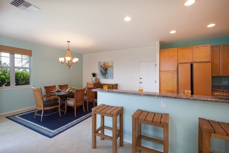 - Open concept layout blends the formal dining space with a casual breakfast bar - Wooden cabinetry and warm tones add a tropical touch to the modern kitchen - Plenty of seating options whether you're sipping coffee or enjoying dinner