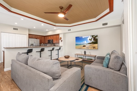 Sink into plush gray sofas while your group gathers around the open kitchen. The warm wood ceiling adds tropical charm to your shared space.