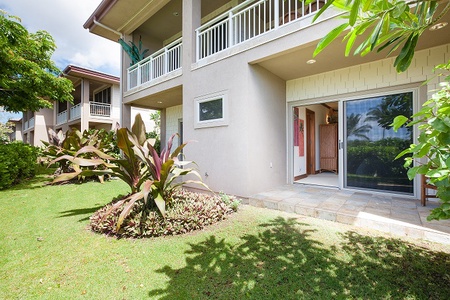 - Private patio opens directly to a beautiful green lawn surrounded by foliage   - Tropical plants and bright natural light create a welcoming outdoor escape   - Convenient sliding door entry offers seamless indoor outdoor living flow
