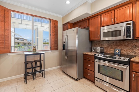Full kitchen with breakfast bar, granite counters, and stainless steel appliances