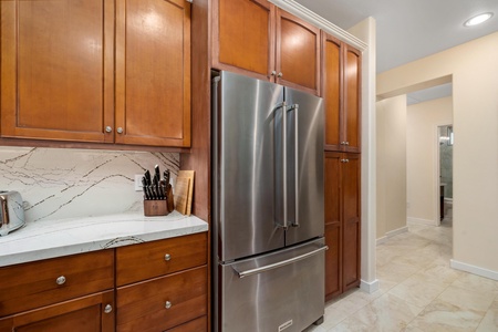 Your fully-equipped kitchen features rich cherry cabinets, gleaming marble countertops, and stainless steel appliances ready for your culinary adventures.