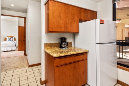 Your spacious kitchen features warm wood cabinetry, granite countertops, and all essential appliances for comfortable home-away-from-home cooking.