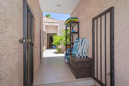 - Handy gated alcove stocked with boogie boards beach chairs and outdoor toys - Tile flooring and open design make post beach cleanup and storage a breeze - Tropical greenery and direct access lead into the home's peaceful interior