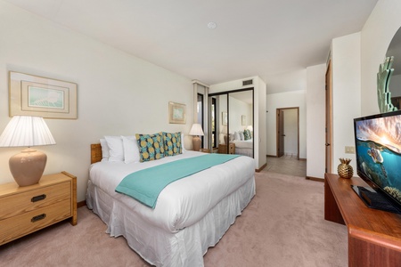 Sink into crisp white linens and tropical-themed pillows in your serene bedroom, complete with modern amenities and calming coastal decor.