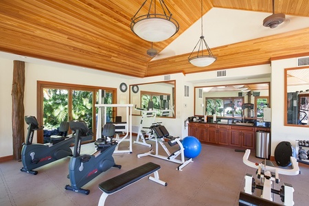 Spacious exercise room with weights, bikes, and training machines.