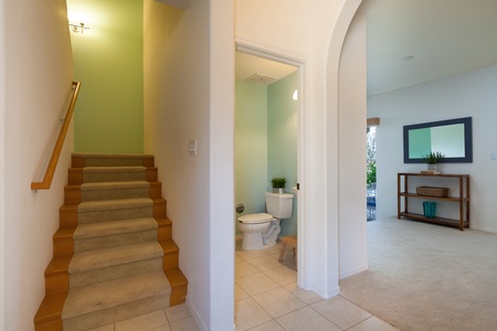 - Tiled entryway leads you upstairs and includes a convenient half bathroom on the main level - Arched accents and soft colors enhance the relaxing island inspired aesthetic - Easy access to all levels of the home, including outdoor and living areas
