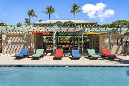 Colorful loungers by the shaded poolside.