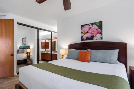 Sink into crisp, fresh linens in your serene bedroom, where tropical flair meets modern comfort. The warm wood tones and pops of color create your perfect island escape.