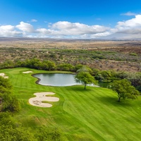 Championship golf course featuring pristine greens and strategic water hazards set against stunning desert landscapes.