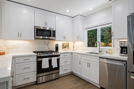 Whip up your favorite meals in this bright, fully-equipped kitchen with gleaming appliances and plenty of prep space.