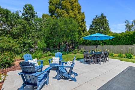Relax in your private backyard oasis with comfortable seating areas and dining space surrounded by lush landscaping.