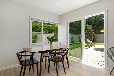 Your bright dining space opens to a private backyard oasis, where morning coffee feels magical with garden views framing every meal.