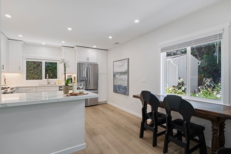 Cook and dine in your bright, modern kitchen with sleek white cabinets, stainless appliances, and a perfect breakfast bar for morning coffee.