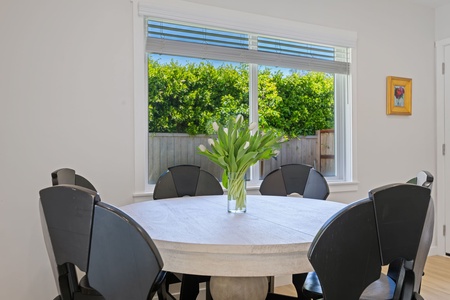 Gather around your bright dining table for memorable meals, with fresh flowers and garden views creating the perfect backdrop.