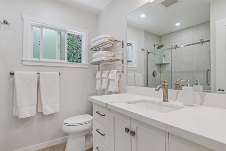 Enjoy your pristine bathroom, glass shower, and fluffy towels waiting for your arrival.