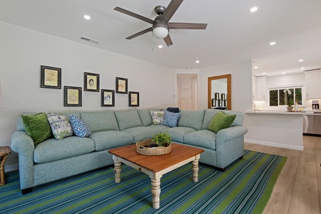 Sink into this spacious sectional sofa where you can unwind after your adventures, surrounded by cheerful artwork and natural light.