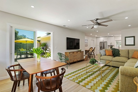 Relax in your bright, modern living space where comfort meets style, complete with dining area and peaceful patio views.