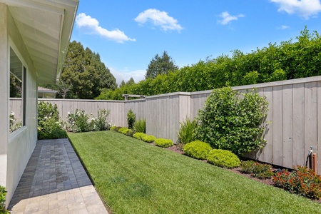 Step into your private backyard oasis with manicured lawn and lush landscaping, perfect for morning coffee or evening relaxation.