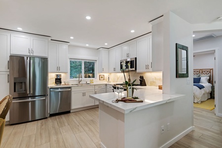 Your gourmet kitchen awaits with gleaming quartz countertops, stainless steel appliances, and a spacious island perfect for cooking memorable meals together.