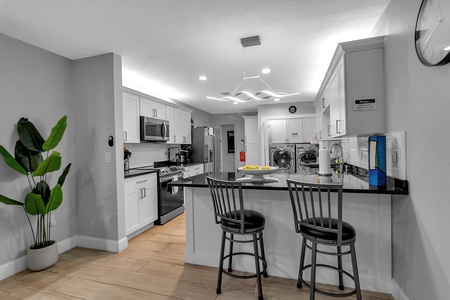 Large Shared Kitchen With Barstool Seating