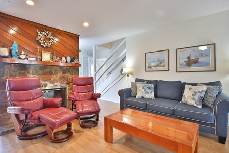 Family room with fireplace behind chairs