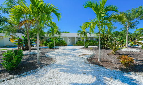 Front Lush landscaping leading to the private entrance of the home