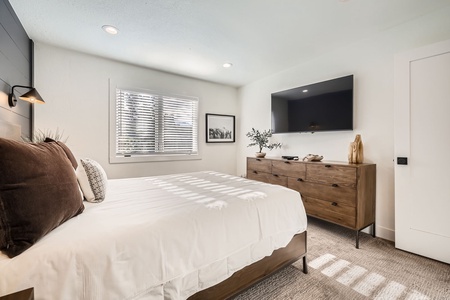 nwind in the serene main bedroom, featuring soft linens, calming decor, and a cozy atmosphere—your private retreat for restful nights and peaceful mornings.