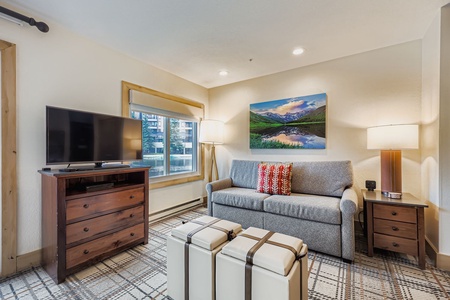 This Intimate Living Room, Perfect For Relaxing, with a Plush Sofa and Natural Light Spilling in From a Window.