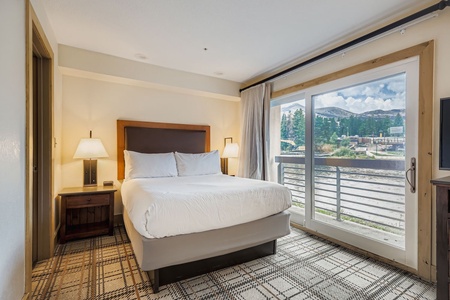 Open-Concept Cozy Primary Bedroom with Large Window
