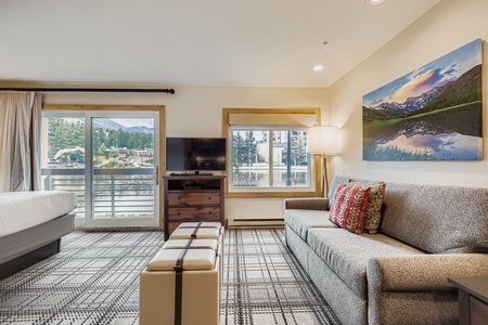 This Intimate Living Room, Perfect For Relaxing, with a Plush Sofa and Natural Light Spilling in From a Window.