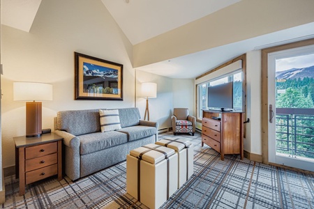 Cozy Living Room with Stylish Gray Sofa, Plaid Carpet with a Large Window for Natural Sunlight