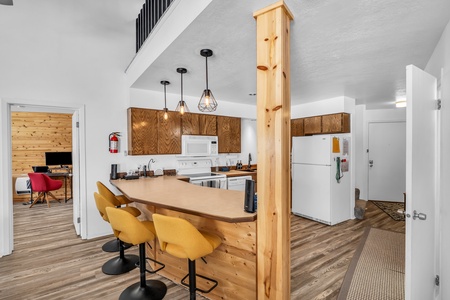 Fully equipped kitchen with modern amenities and counter seating for four